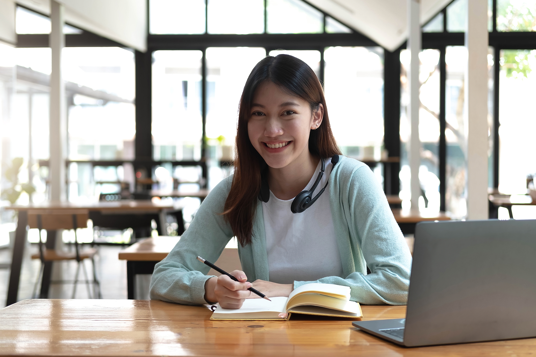 Young Woman Next To Her Computer - One of the key users of VPN services.